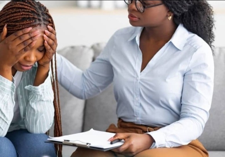 A counsellor comforting a client during a depression therapy session